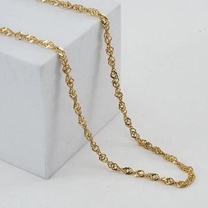 Detailed view of 18K gold-plated stainless steel water wave chain on a display stand