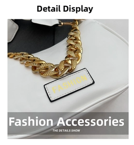 Close-up of white underarm bag with thick gold chain and Fashion embossed leather patch