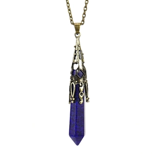 Macro shot of Lapis Lazuli hexagonal crystal pendant with bronze vintage metal cap