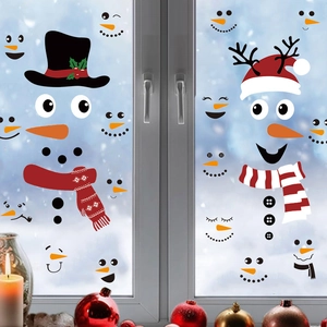 Christmas snowman face window stickers with red scarf and hat on snowy glass background