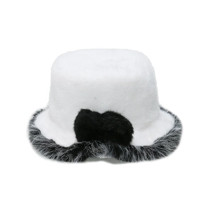 Close-up of white faux fur bucket hat featuring a black plush bow and trim details