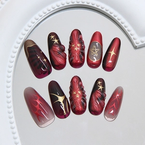3D star charms and red-black gradient cat-eye press on nails on a white vintage tray