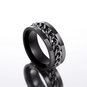 Close-up of matte black stainless steel ring with spinning silver Cuban chain detail
