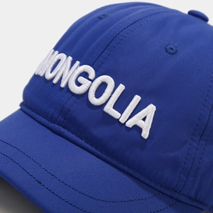 Close-up of white 3D embroidery text MONGOLIA on navy blue short brim baseball cap