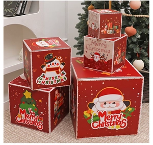 Close-up of festive red Christmas gift boxes with Merry Christmas motifs and cartoons