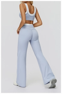 Close-up of light blue high-waisted yoga set featuring flared pants and cross-back sports bra