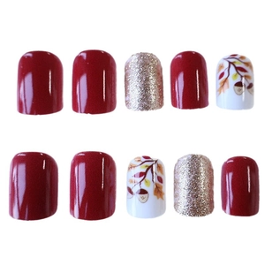 Short square press-on nails with autumn leaves, acorns, and burgundy glitter finish