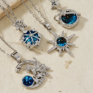 Detailed shot of celestial stainless steel necklaces with blue stones and moon star pendants