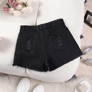 Detailed flat lay of high waist black distressed denim shorts with frayed hems and ripped texture