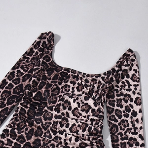 Detailed close-up of leopard print long sleeve dress with square neck and ruched bodice