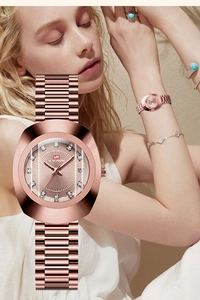 Close-up of elegant rose gold women's watch with textured dial and diamond markers