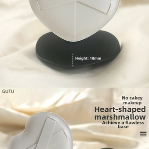 Detail view of heart-shaped makeup sponge showing 18mm thickness on silk background