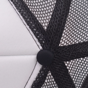 Close-up of black hexagonal mesh and white fabric seams on a trucker hat top