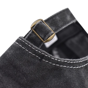 Detail of adjustable metal buckle and vintage washed fabric on the black baseball cap
