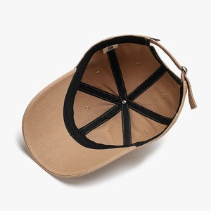 Inside view of khaki cotton baseball cap with black reinforcement tapes and adjustable buckle