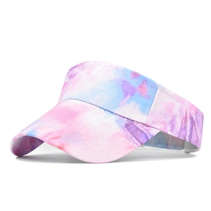 Detailed view of tie-dye sun visor hat with pink and blue patterns and stitched brim