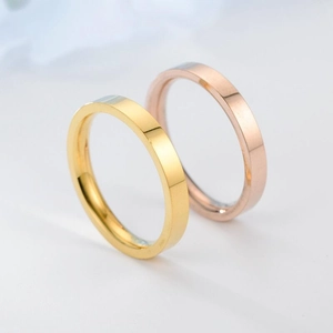Macro shot of 3mm minimalist polished titanium steel rings in gold and rose gold