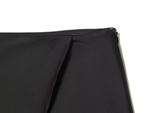 Detail of the high-quality invisible side zipper on a black irregular lace-up skirt