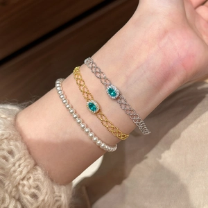 French vintage bracelet set with square zircon green gemstone and pearls on model wrist