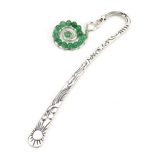 Detail of vintage silver bookmark featuring sun carvings and a green bead spiral pendant