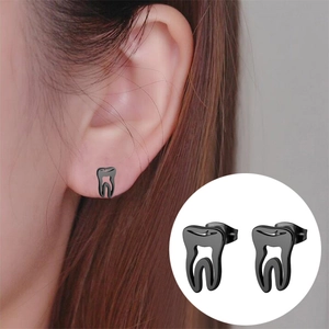 Detail view of gothic style black tooth stud earrings for women in creative dental shape