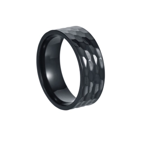 Macro detail of 8mm wide black titanium steel ring with hammered texture and matte finish