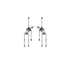 Detail of silver gothic skeleton drop earrings with movable joints for women
