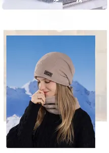 Detail of winter knitted beanie and neck warmer set with warm fleece lining and mountain label