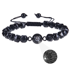 Detailed view of faceted tiger eye bead bracelet with 100 languages I Love You projection