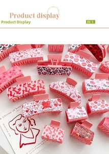 Flat lay of pink heart and leopard print hair claws with romantic Valentine's Day patterns