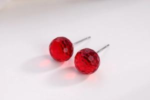 Macro shot of S925 sterling silver studs with faceted dark red crystal spheres