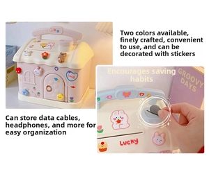Detailed view of cream-colored house money box with cute stickers and storage slots