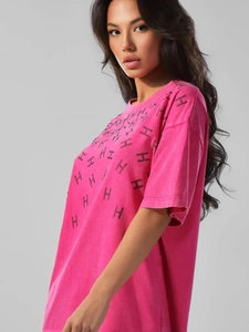 Macro shot of hot-fix rhinestone H-pattern on vintage washed pink cotton t-shirt