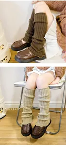 Detail of ribbed knit leg warmers in coffee and beige with wavy edges for winter