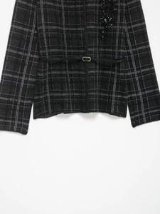 Detailed view of grey plaid knit blazer featuring sequin embroidery and slim waist belt