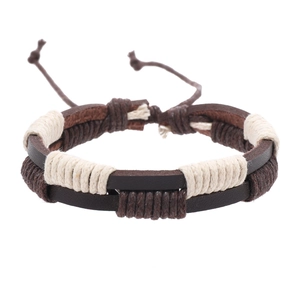Close-up of brown leather bracelet with beige woven rope detailing and vintage style