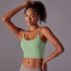 Detail of high-impact light green seamless sports bra with thin straps and matte finish