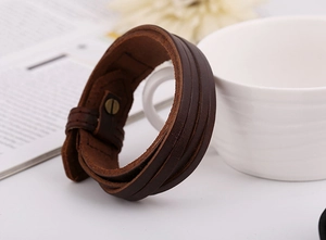 Close-up of brown multilayer genuine leather bracelet with metal snap button closure