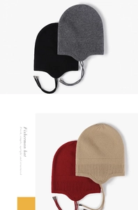 Detail view of four colorful winter knitted earflap hats with metal drawstring tips
