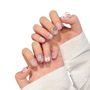 Pink handmade press-on nails with 3D floral, bow, heart designs and crystal details