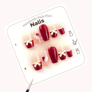 Handmade wine red and white French bow press-on nails with pearl accents and heart designs