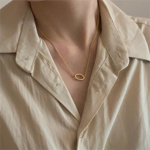 Minimalist 925 sterling silver oval layered necklace with gold finish on a model
