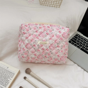 Quilted floral makeup bag detail showing cotton texture and delicate flower patterns