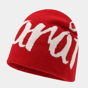 Street style red knit beanie with white graffiti lettering jacquard for winter warmth
