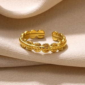 Macro detail of adjustable gold chain ring with fine textured links and matte finish