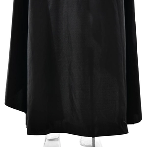 Detail of black woven evening dress hemline featuring a high slit and elegant drape
