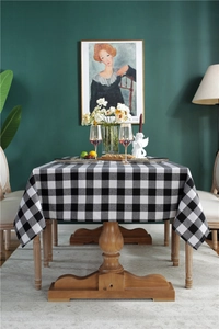 Close-up of black and white buffalo plaid tablecloth with woven cotton texture and drape
