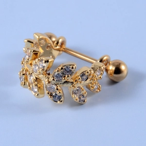 Macro detail of gold-plated leaf stud earring with cubic zirconia and screw-back ball closure