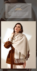 Detail of soft beige pashmina scarf with tassel fringe and elegant knit texture