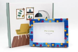 Close-up of a blue DIY building block photo frame with colorful stars and packaging box